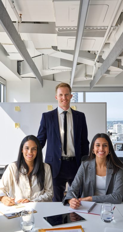 Happy professional diverse team business people in office meeting room. International company workers group, multiethnic smiling employees colleagues staff posing for team vertical portrait.