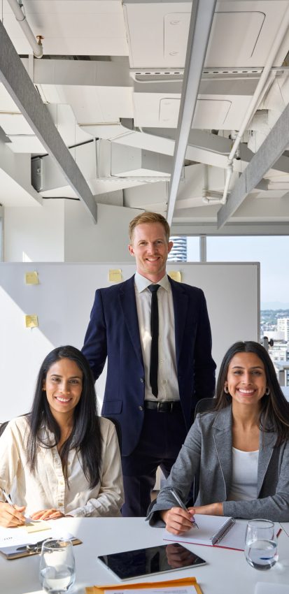 Happy professional diverse team business people in office meeting room. International company workers group, multiethnic smiling employees colleagues staff posing for team vertical portrait.